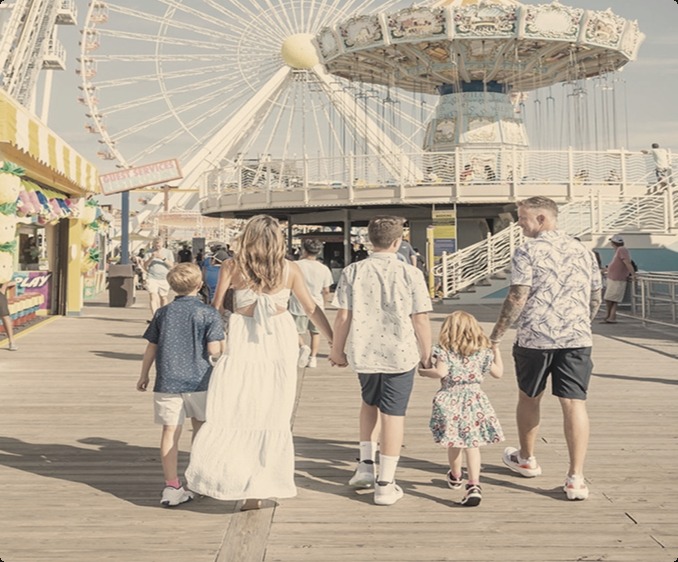 The Maher family walking the boardwalk amusement pier